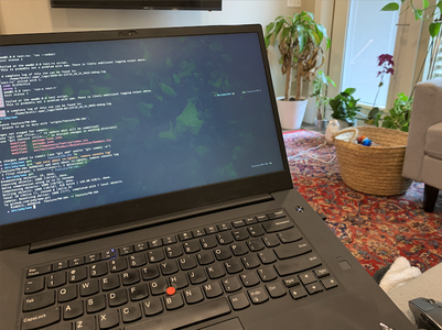 ThinkPad laptop on person's lap with terminal open